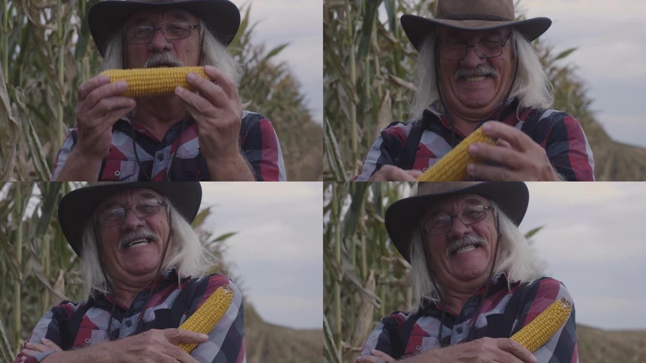 兴奋的高级农民亲吻玉米