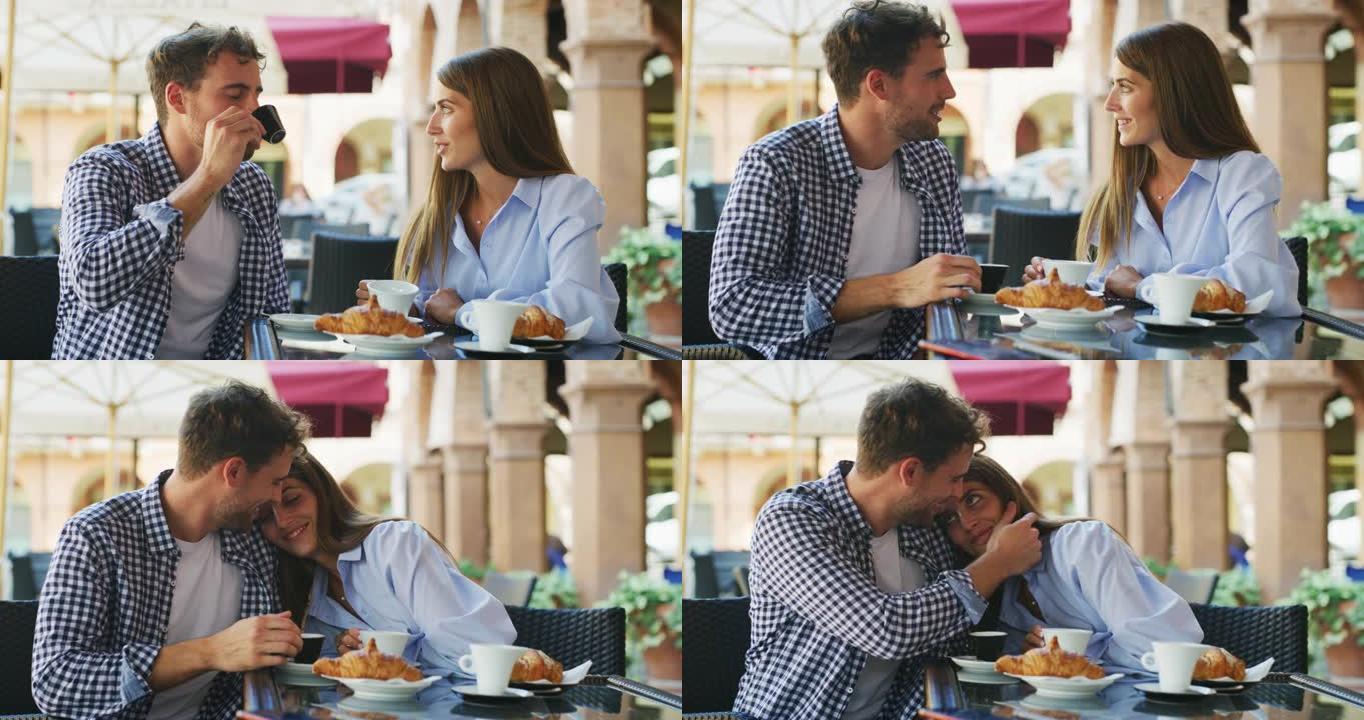 一对年轻的无忧无虑的浪漫爱情幸福夫妻在阳光明媚的周末在市中心自助餐厅一起享用早餐的同时，享受着乐趣和