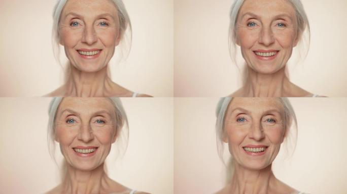 看着镜头，微笑着的高级女性的肖像。有着天然灰色头发、蓝色眼睛的老年女士。优雅的老年概念，用于护肤，美