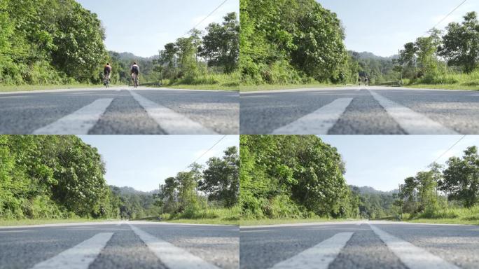 专业自行车手早上在乌卢兰加特农村地区骑公路旅行，两名铁人三项运动员骑手