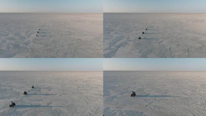 空中飞越游客在博茨瓦纳壮观的Makgadikgadi平底锅的广阔空间里骑四轮摩托的乐趣