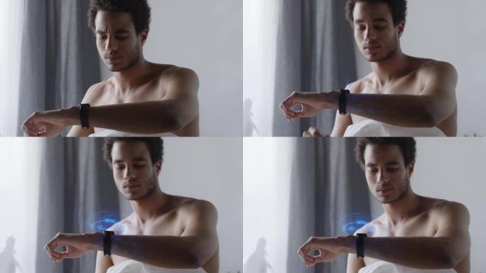 非洲男子在卧室使用带有全息显示的智能手表
