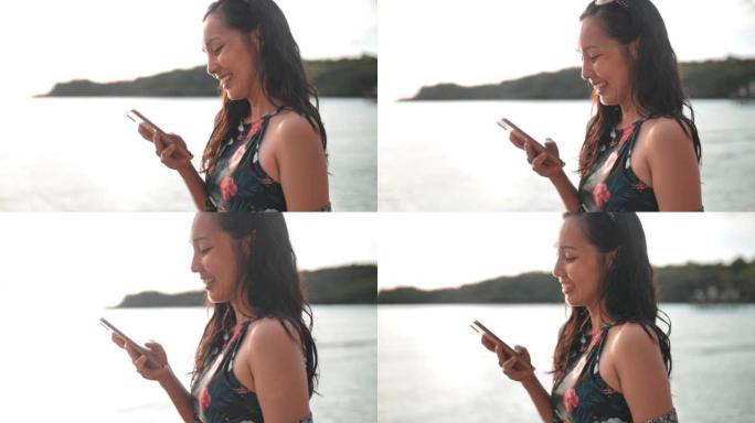 女人在海滩上使用智能手机