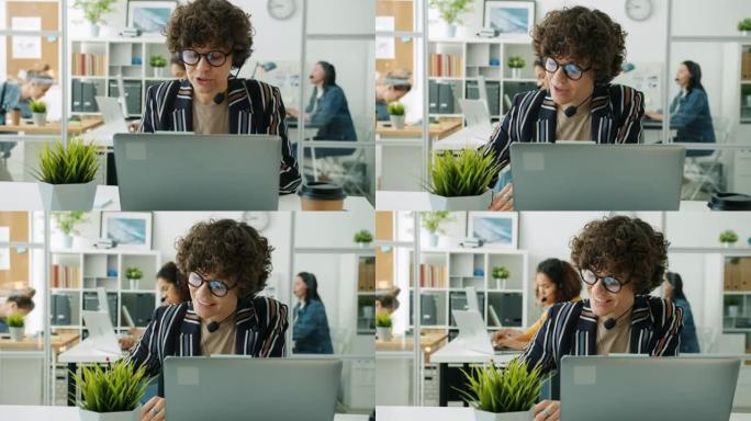 有吸引力的女士呼叫中心工作人员在工作场所用笔记本电脑打电话和打字的肖像