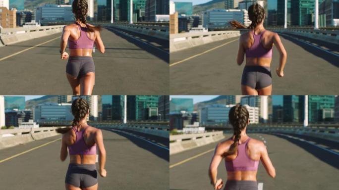 健身女性，城市跑步者，并在城市桥梁的道路上进行训练，从后面进行有氧运动。跑步时的运动动机和运动锻炼，
