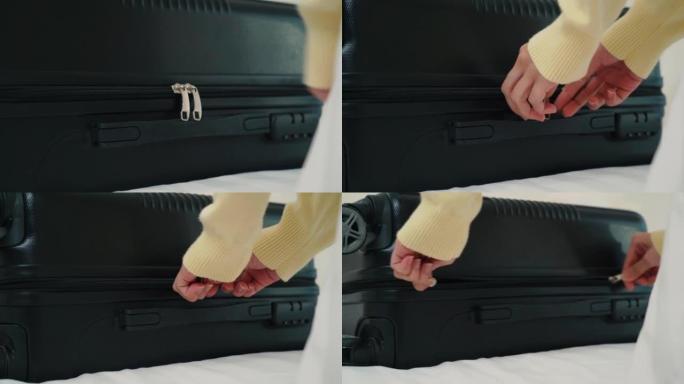 亚洲女人打开行李袋拉链的特写手