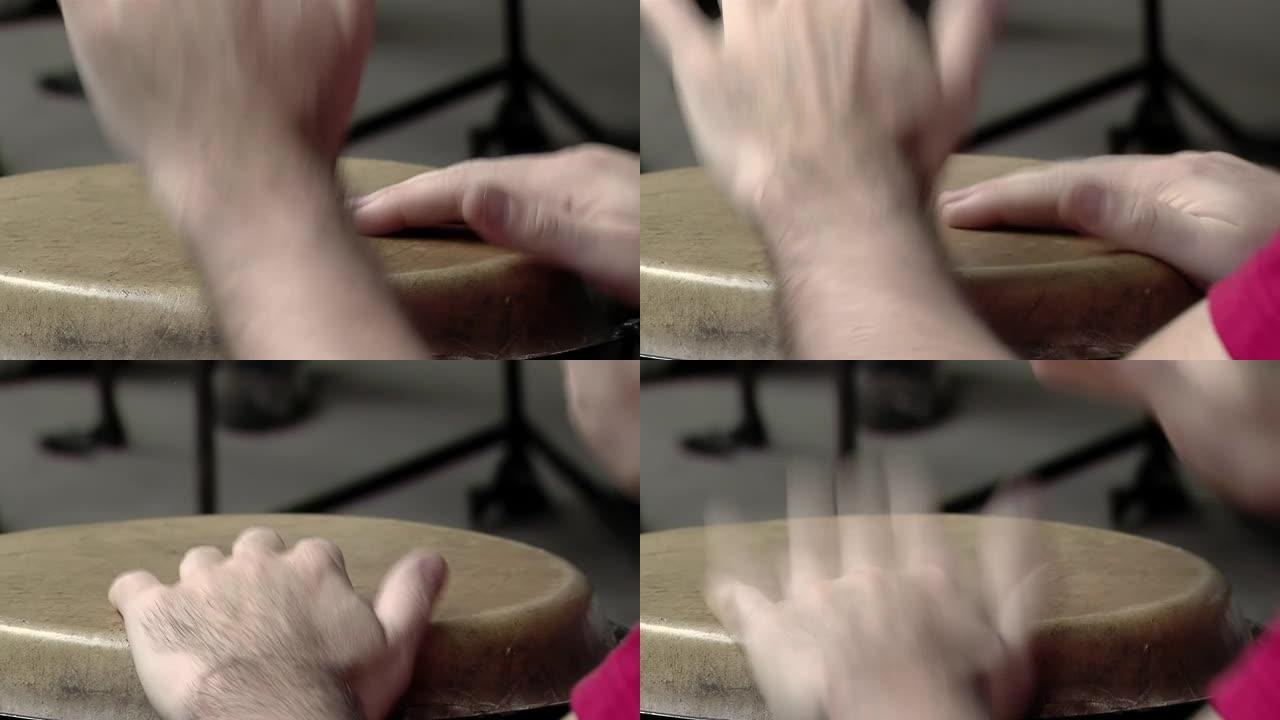 一个演奏康加鼓的男鼓手的手。特写。