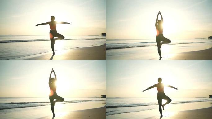 日落时在沙滩上练习瑜伽的亚洲女性