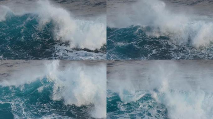 海洋中带有白色泡沫的巨浪。慢动作4k拍摄暴风雨海浪。绿松石色波浪的海洋