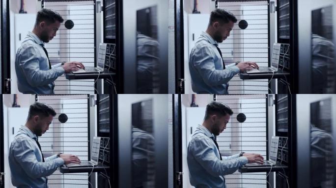 一个年轻人在服务器室工作时使用笔记本电脑的4k视频片段