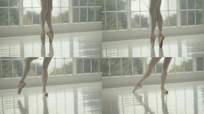 在白色工作室中，芭蕾舞演员1英尺穿着足尖鞋或专业古典芭蕾舞演员的腿站在脚趾上跳舞的特写镜头。编舞表演