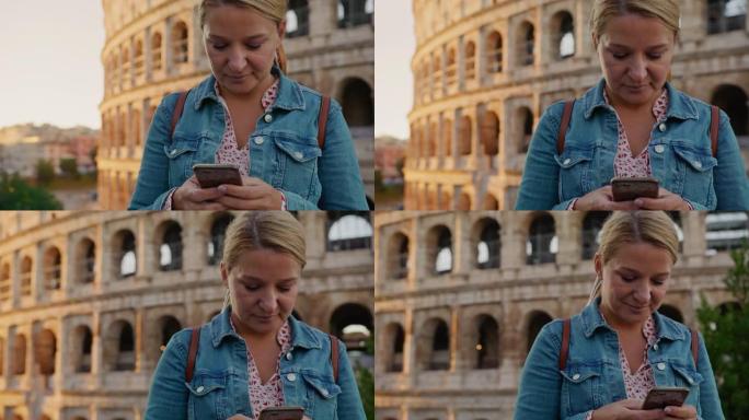 SLO MO女游客在罗马罗马斗兽场使用智能手机