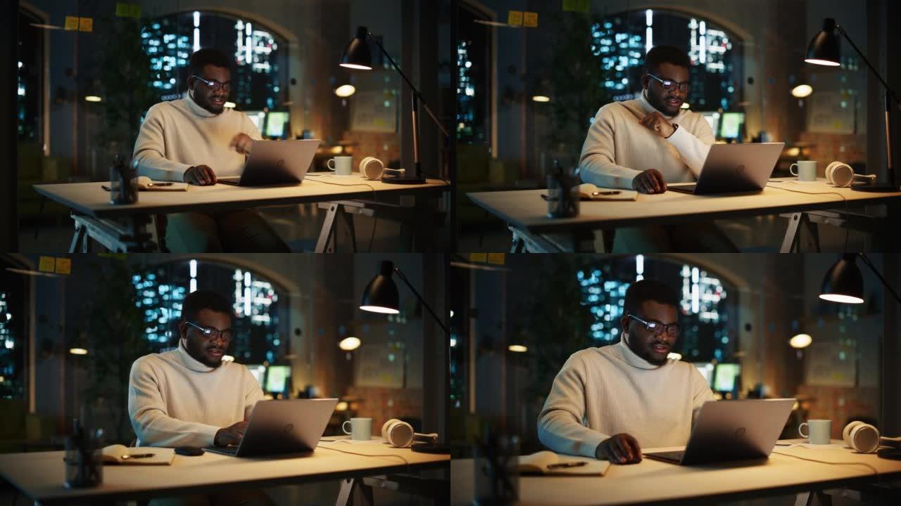创意项目经理坐在办公桌前，晚上在办公室的笔记本电脑上工作。非洲营销专家计划一个项目，浏览互联网和写电