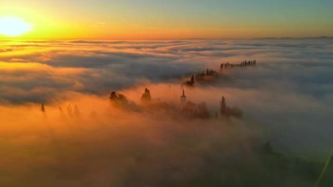 日落时分，空中浓雾笼罩在小山和周围的乡村