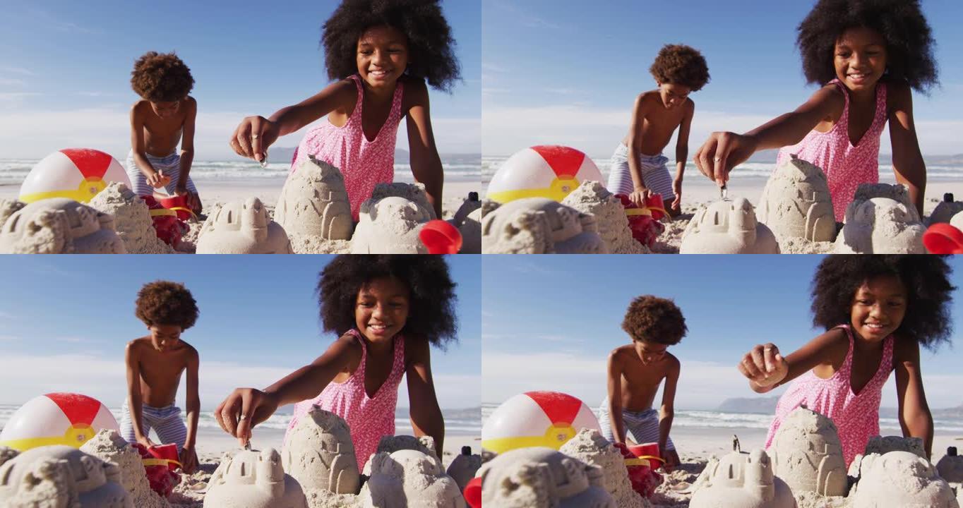 非裔美国兄妹在沙滩上玩沙子