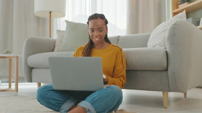 4k视频片段，一名年轻女子坐在家里使用笔记本电脑