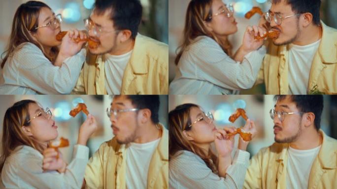 夫妇在亚洲餐厅享用和分享木瓜沙拉，享受晚餐。