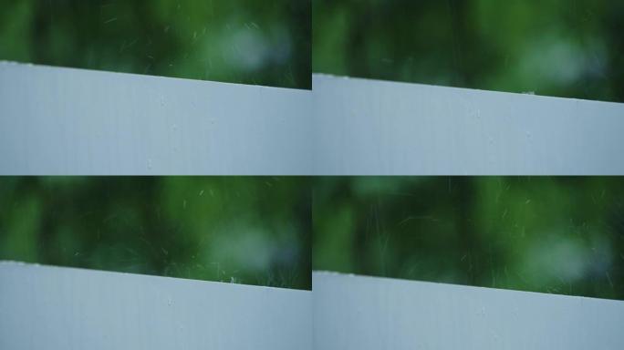慢镜头2x雨滴落在白色的墙上