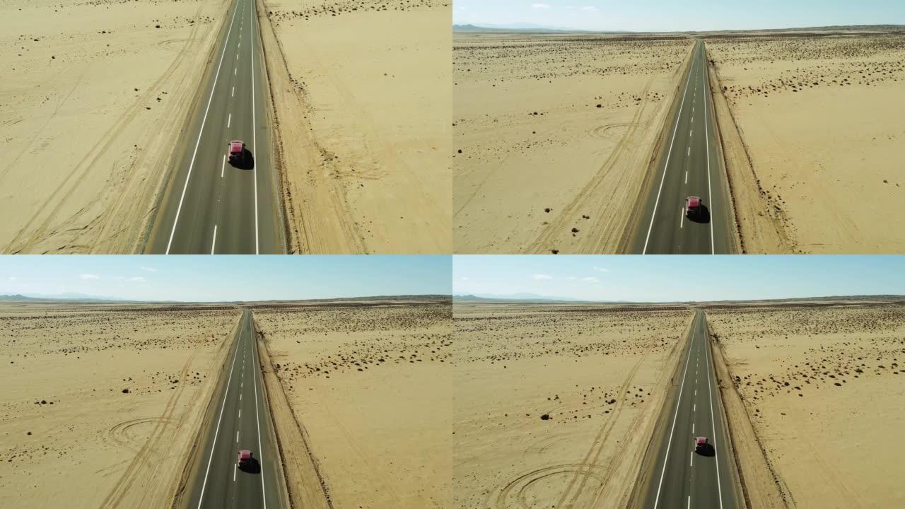 汽车在南美智利阿塔卡马沙漠中的公路上行驶。无人机视图。