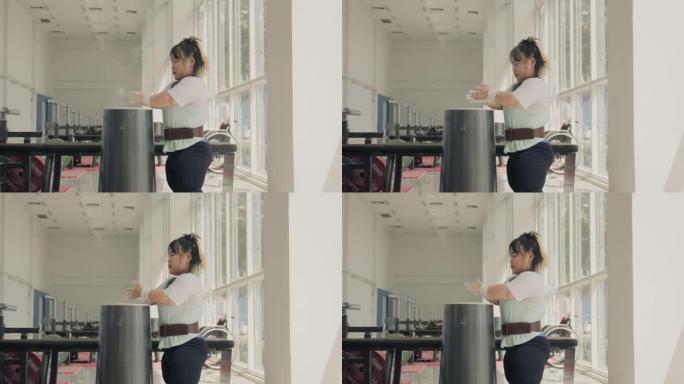 坐轮椅的亚洲女运动员在健身房锻炼前做好准备。
