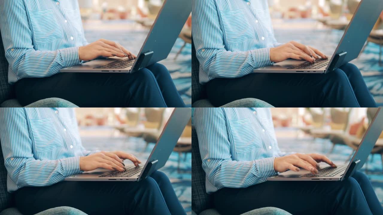 一个涂指甲的女人正在笔记本电脑上打字