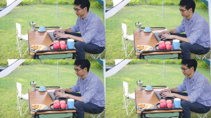 露营时在户外工作的商人