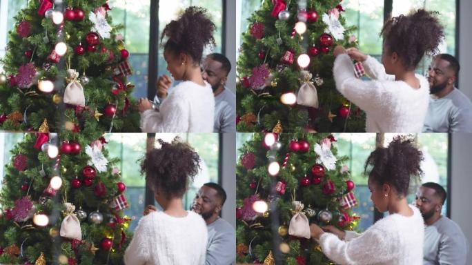快乐的非洲女孩孩子与父亲装饰圣诞节，快乐的家庭和圣诞节场景概念