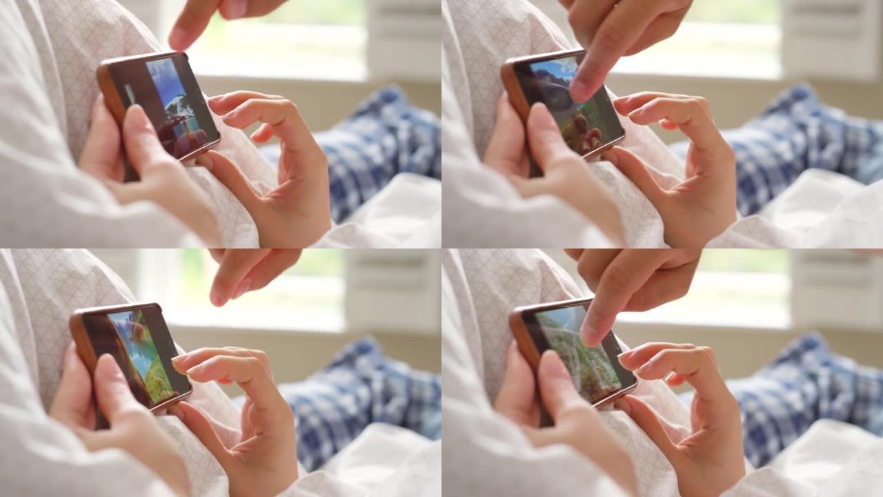 一个无法识别的男子使用智能手机观看照片的4k视频片段