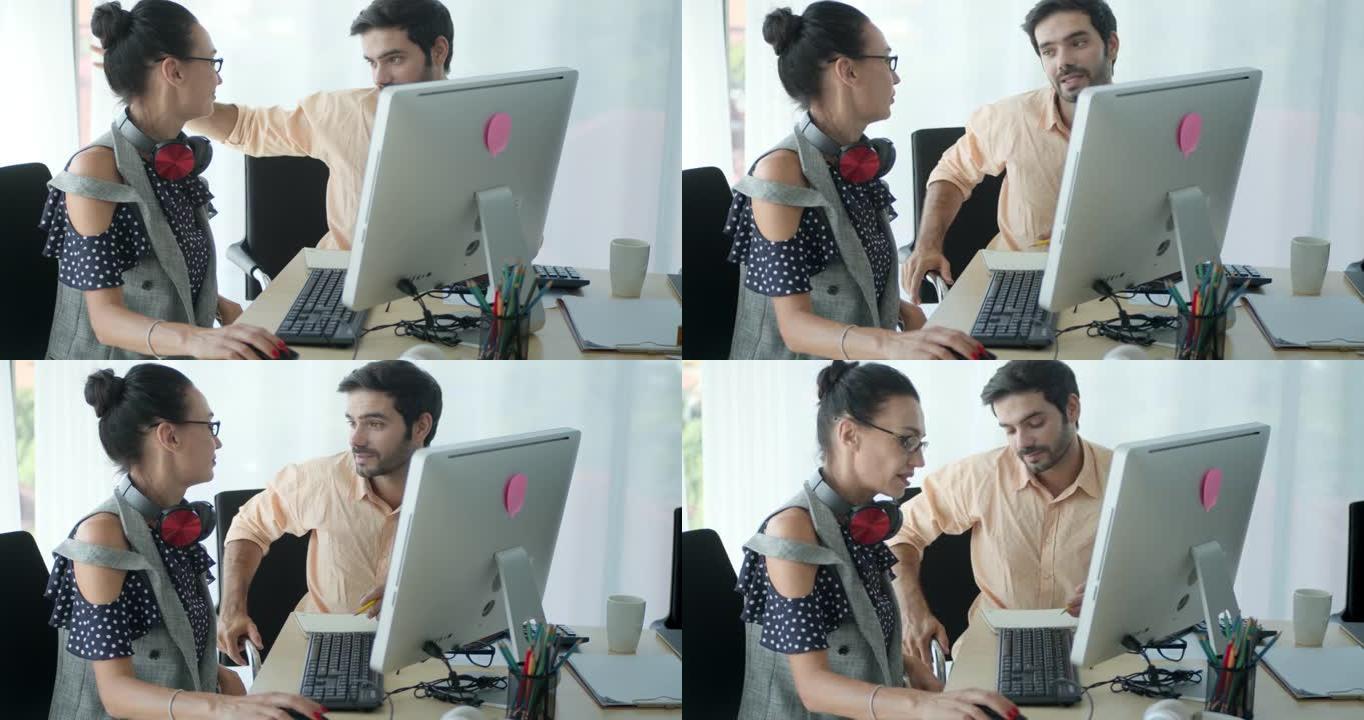 SLO MO两个同事使用计算机并在现代办公室中讨论，跟踪镜头