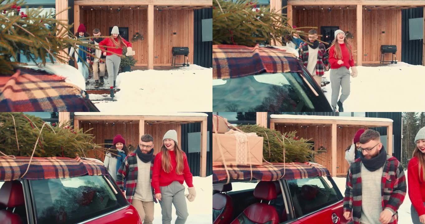 节日气氛。快乐的年轻多样化的朋友走到红色的汽车上，在冬季家庭聚会慢动作时，屋顶上有圣诞树。