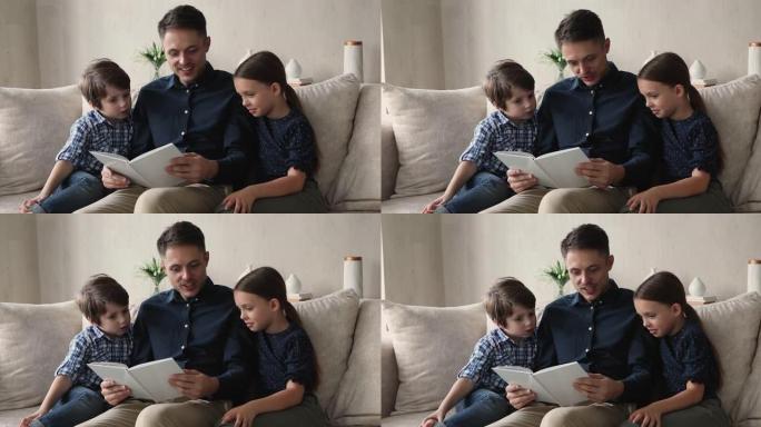 快乐的年轻父亲给小孩子读纸质书。
