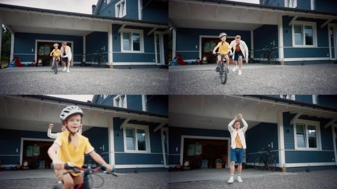 快乐的父亲带儿子在他们家前院的草坪上骑自行车。小男孩戴着头盔，骑自行车保持平衡。骄傲的爸爸为他的成功