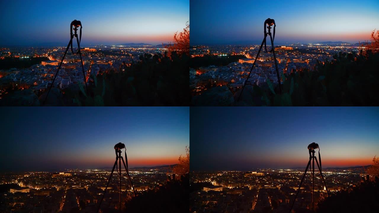 三脚架上的WS相机等待晚上拍摄雅典的城市景观