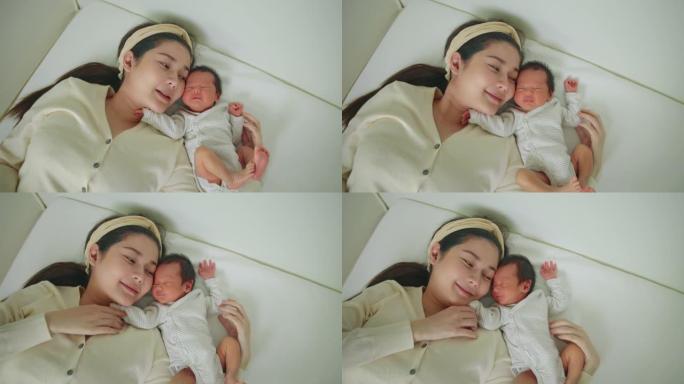 妈妈和熟睡的新生婴儿玩耍。保险人寿