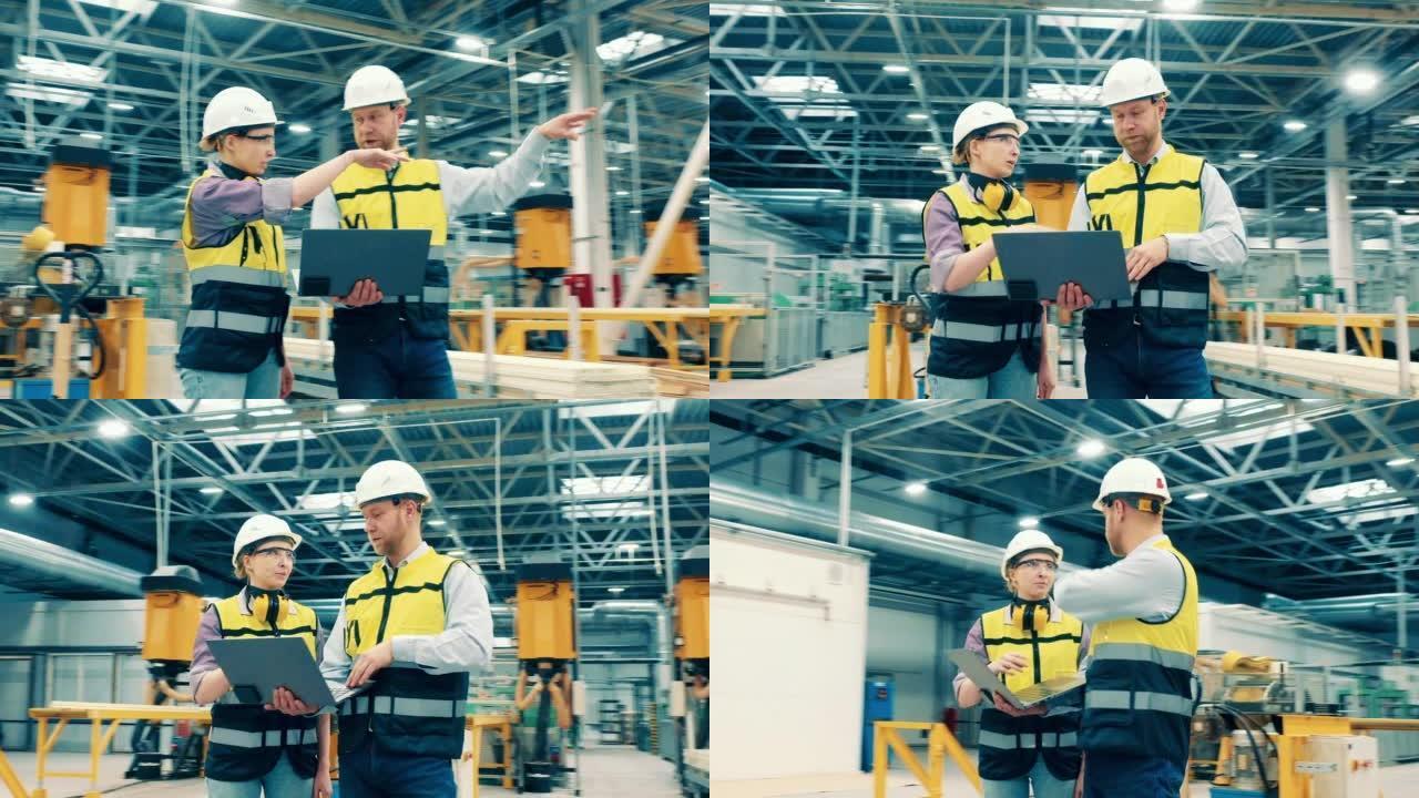 现代工厂设施，两名工程师戴着安全帽