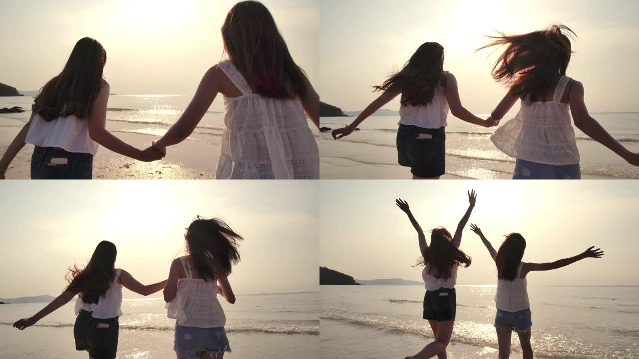 两个年轻的女性朋友在日落海滩玩得开心
