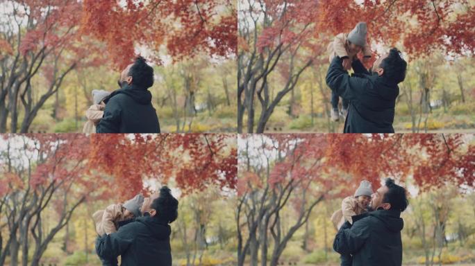 快乐的父亲和可爱的女儿在秋季公园玩得开心。