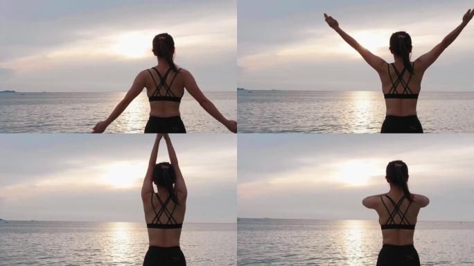 健康的亚洲年轻女子马尾辫在海边练习瑜伽