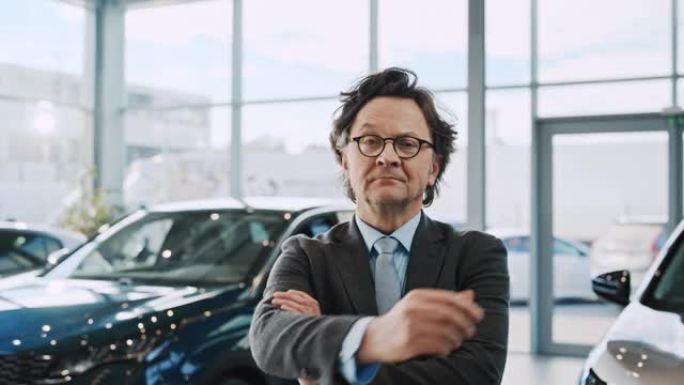 一位成功的汽车推销员的SLO MO肖像在汽车陈列室中摆出满意的姿势
