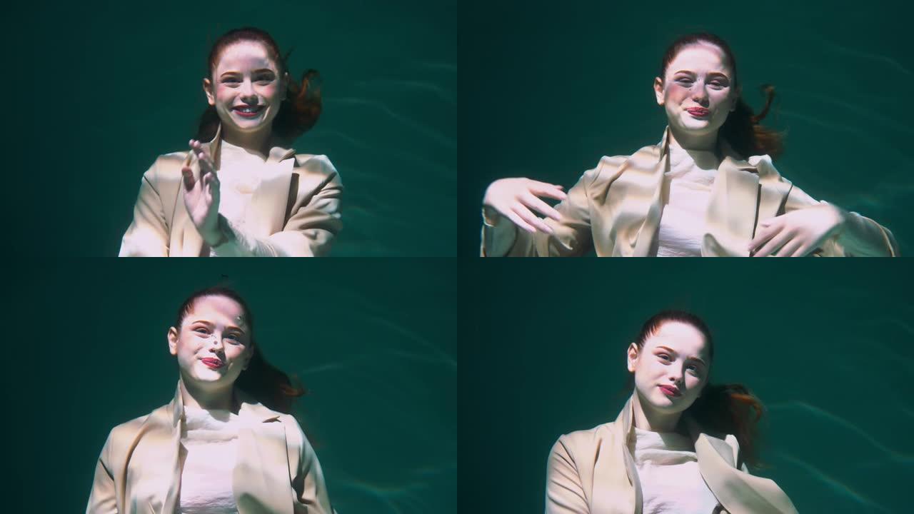 大气的电影肖像，快乐美丽的年轻女商人潜水水下微笑镜头慢动作。