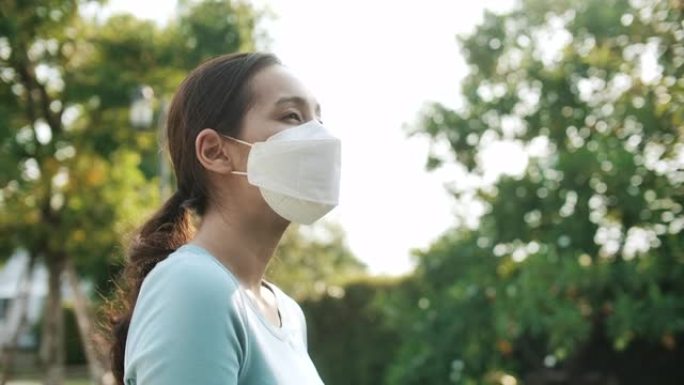 亚洲妇女与保护面具在新型冠状病毒肺炎病毒解决方案的希望