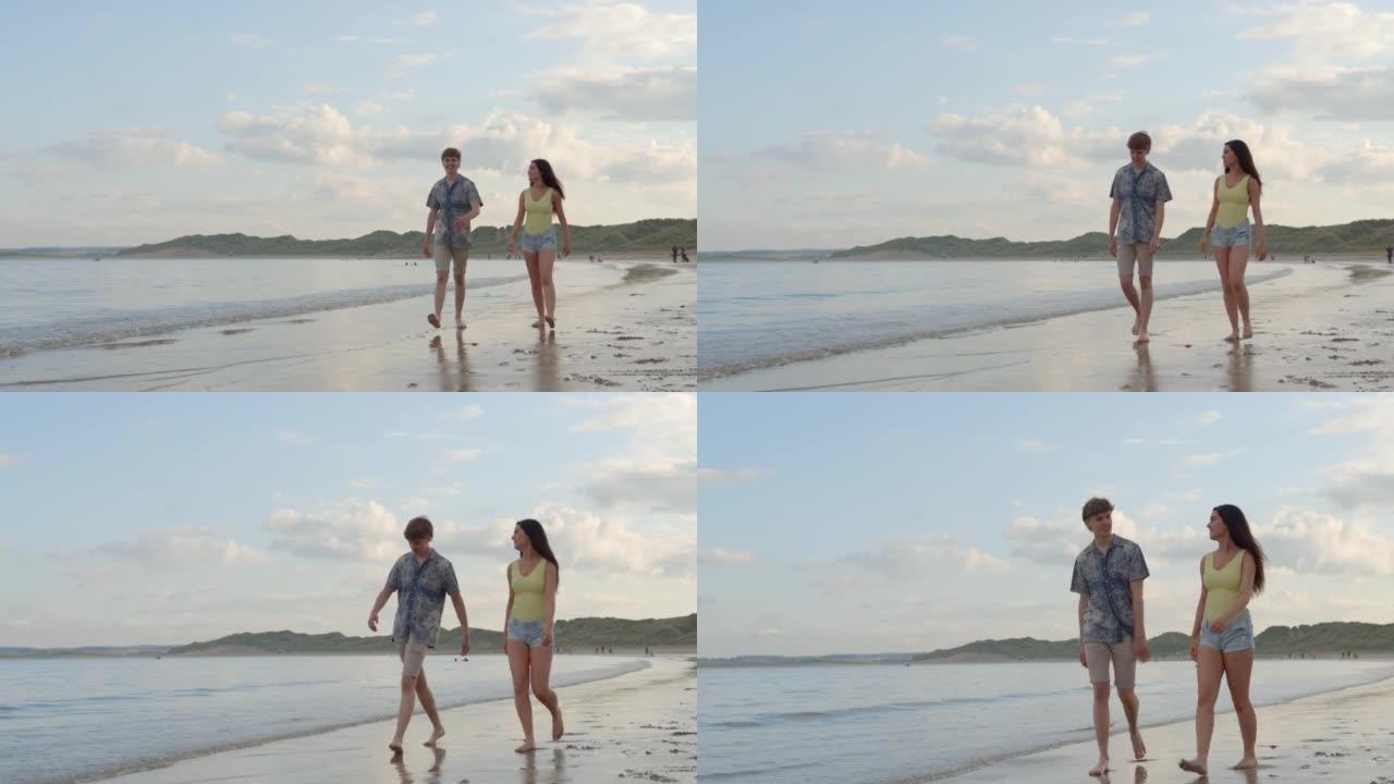 海滩上的幸福夫妇边走边说