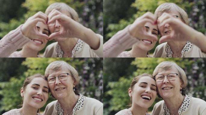 母女俩摆姿势拍照的4k录像用手做成心形