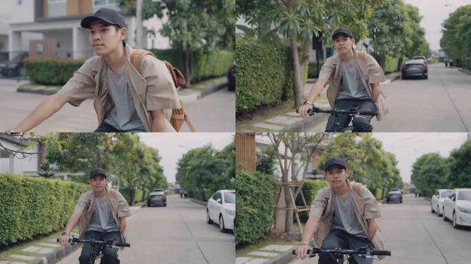 年轻的时髦男子戴着帽子，早上在城市里骑自行车。