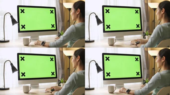 女人使用绿屏电脑绿幕抠像办公抠绿