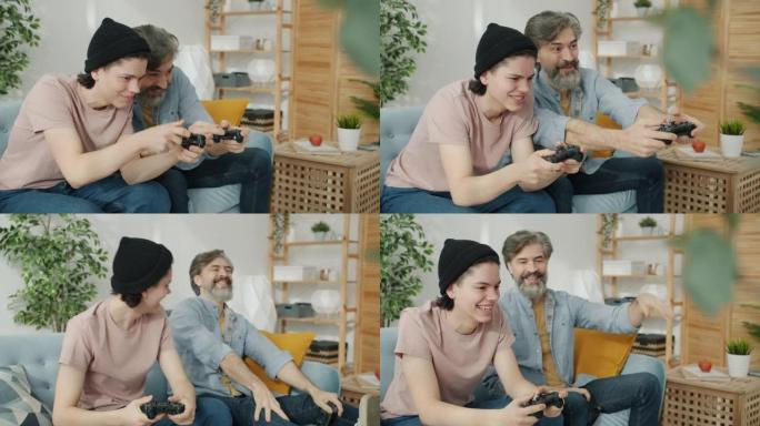 享受电子游戏的父子肖像在室内做高五手势