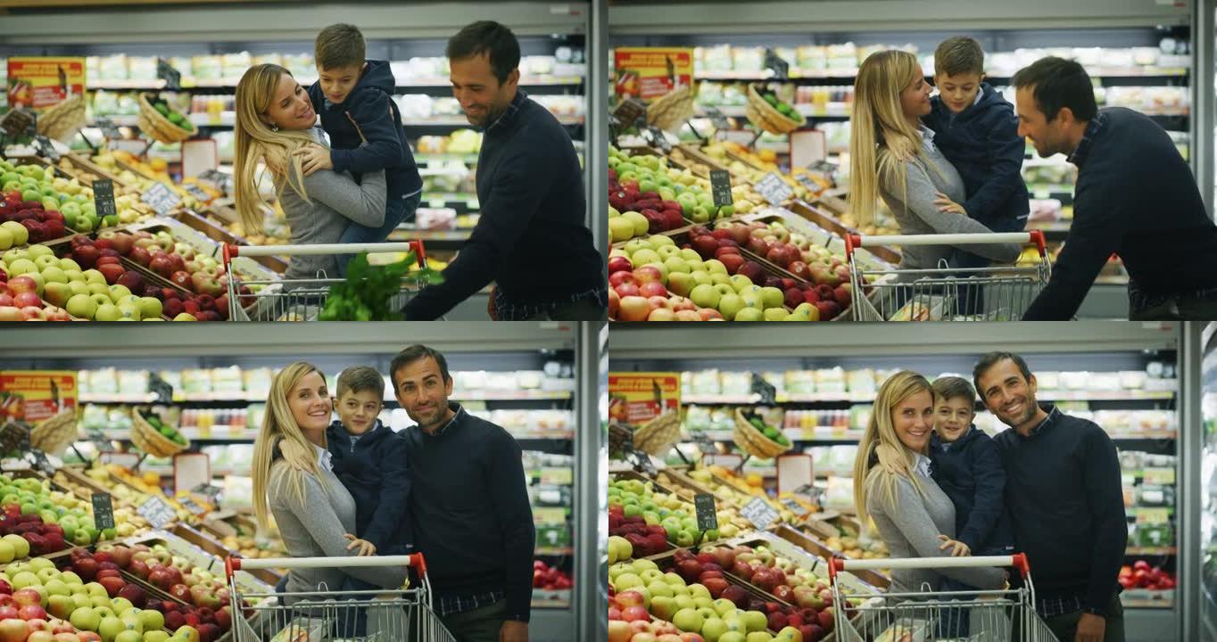 父亲，母亲和儿子的幸福家庭的真实照片在相机中微笑，同时在超市一起购物。