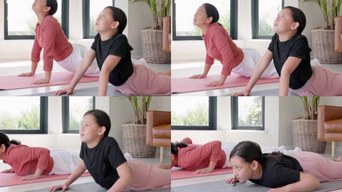 健身，家庭和亚洲瑜伽由母亲和女儿在地板上锻炼，冥想和健康锻炼在家庭普拉提中，女孩和妈妈训练，放松与和