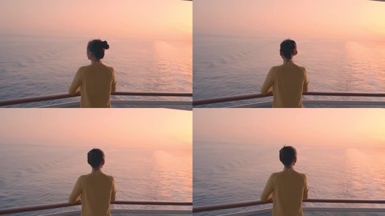 在游轮豪华旅行生活方式的剪影中，女人在私人阳台甲板上观看日落。