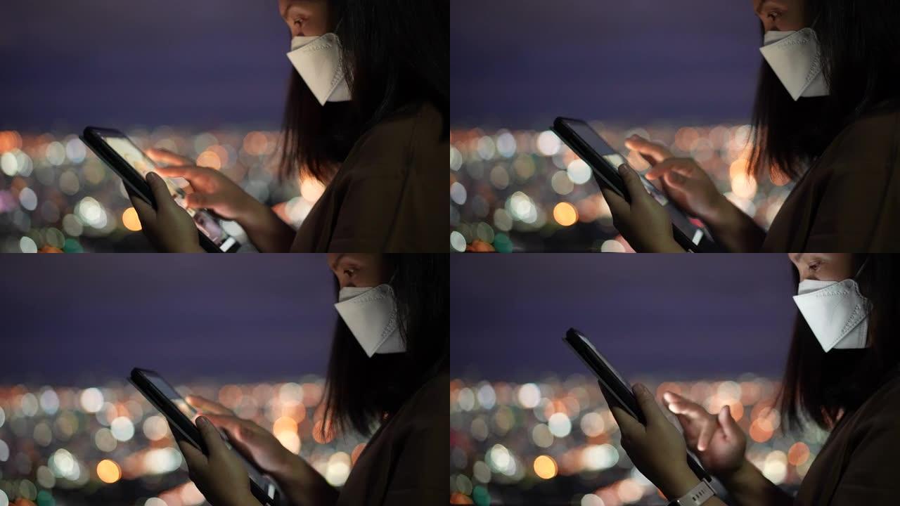 女人在夜间使用数字平板电脑，来自城市的circle light bokeh